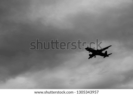 Scenery of airplane flying  in dark sky of rainy season to the destination.  Show high performance technology of transportation in the world. The symbol of going through problem to the target.