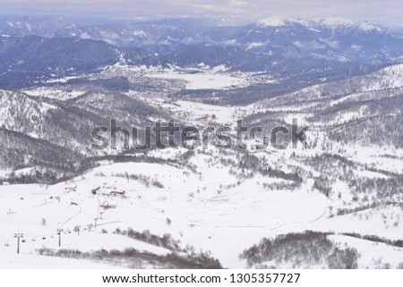 view from the mountain to the ski slope,mountains covered with snow,beauty of nature