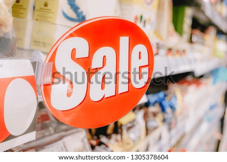 Sale tag on shelf, sell and shopping on line concepts with blur supermarket background, e-commerce, business concepts.