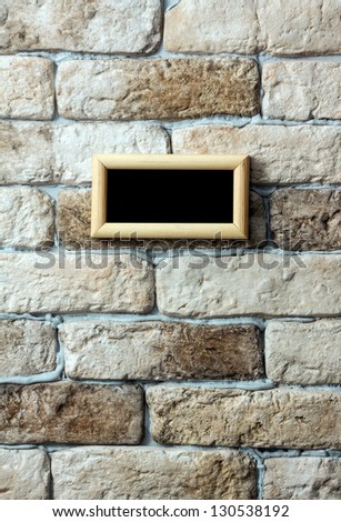 blank photo frame on old brick wall