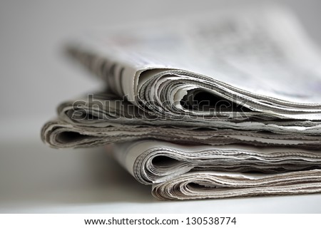 Newspapers folded and stacked concept for global communications Royalty-Free Stock Photo #130538774