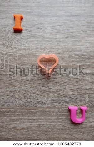 'i love u' word Close-up shot selective focus colorful, magnetic letters with romantic question for Valentine's Day