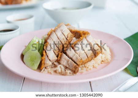 Hainanese rice with crispy pork , Thai gourmet steamed crispy pork rice , street food in thailand