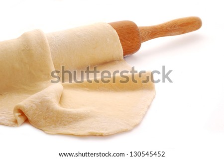 dough and rolling pin over white background Royalty-Free Stock Photo #130545452