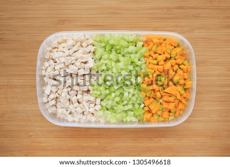 Chopped and sliced Taro, Chayote and Japanese Pumpkin in plastic tray on wood board background.