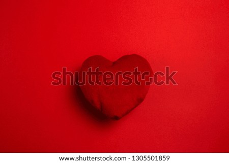 red soft heart on red background