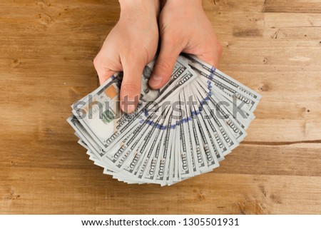 hand, money dollars usa - Image on wooden background