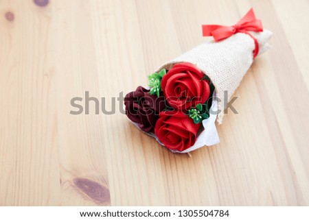 A couple gift roses on valentine day on wooden table in the kitchen, empty space for design