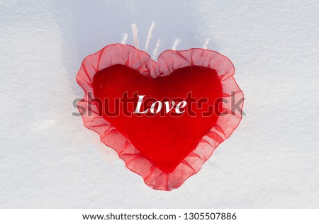 Background. On St. Valentine's Day a hot heart on snow