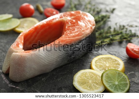 Raw salmon steak on grunge background, closeup