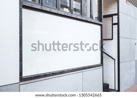 Empty white banner on building. Advertisement, ad and commercial concept. Mock up 