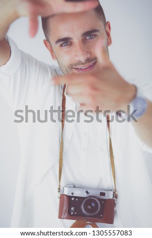 Young man with camera. Isolated over white background