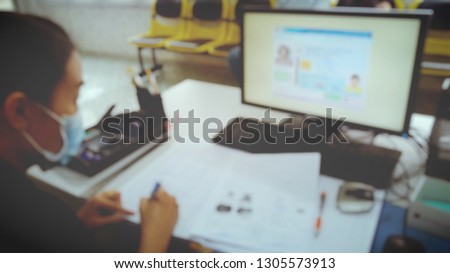sick office woman working with computer screen and stationery Card scanner And ID cards put on the table, Registration, blurred photo
