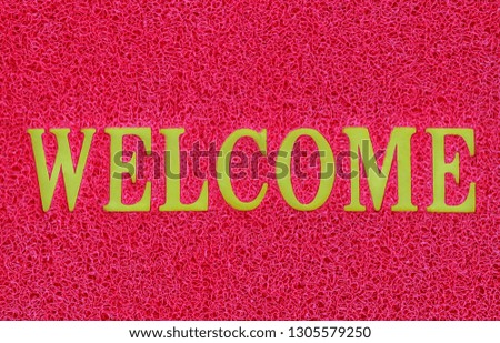 doormat and welcome word, Photo of a welcome door mat isolated on a red background