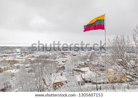 Lithuanian flag in the wind. Kaunas city in the background. Drone aerial view.