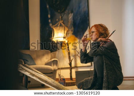 woman painting paint in her atelier