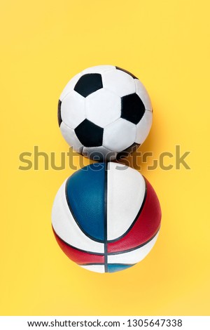 The conceptual composition from soccer football and basketball balls about Eight march womans day holiday on a yellow background. The number 8 in decor. Top view. The women in sport and fitness