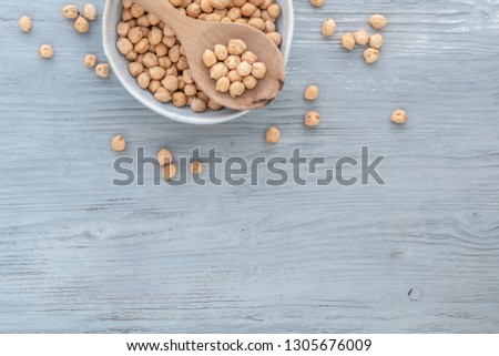 Chickpeas in a bowl on a light wooden background