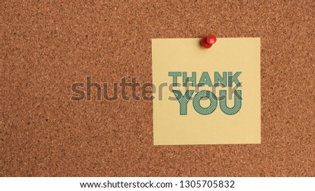 Note with the words thank you on cork board