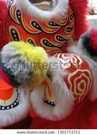 close up details of red and yellow colour Chinese new year traditional lion dance head ready for celebrating Chinese events like new year, office blessing or house opening ceremony.