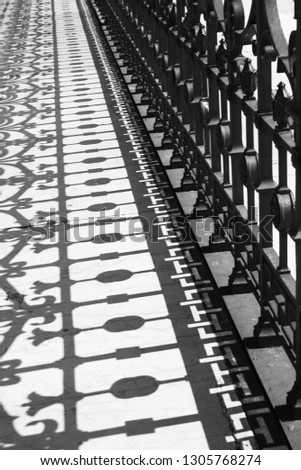 The shadow of the metal fencing bridge, background