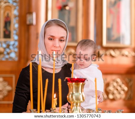 Young woman with a baby in church