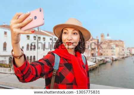Happy asian woman taking selfie in Venice. Travel vacation in Italy and Europe concept