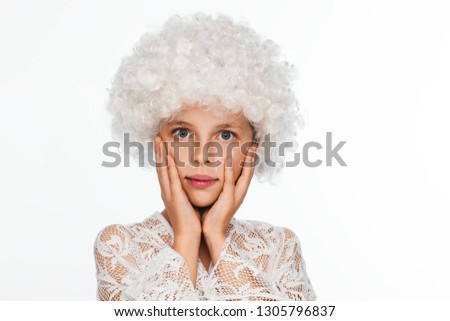 Portrait of a cheerful, energetic eight-year-old girl in a white wig and with white freckles. White background