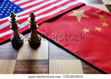 Chess game. Two kings face to face on Chinese and American national flags. Trade war and conflict between two big countries. USA and China relationship concept. Copy space. Royalty-Free Stock Photo #1305802843