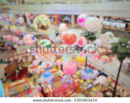 Blurred picture of department store that decorated in Chinese New Year theme. Festival concept.
