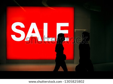 Sale sign in mall and shoppers silhouettes
