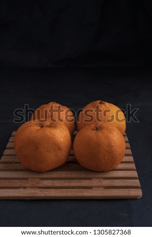 Orange fruits isolated on black background, Lunar Chinese New Year theme concept.