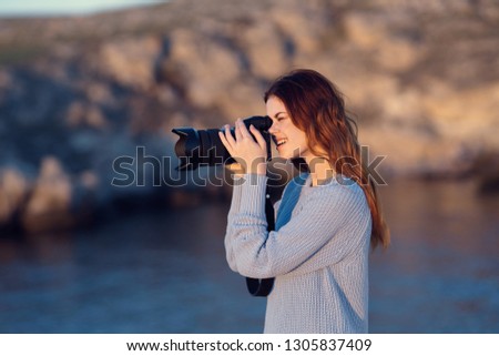 tourist in  sweater autumn nature  mountains camera in hand
