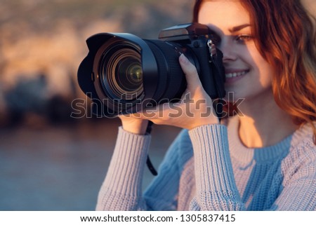 tourist in  sweater autumn nature  mountains camera in hand big lens