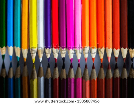background of colored pencils, with reflection