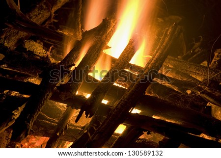 Camp fire with stacked wood