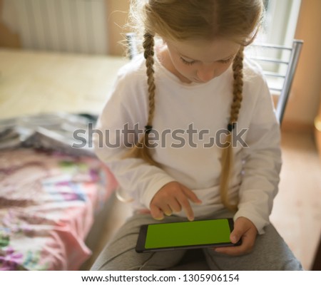 Girl playing with tablet pc. Selective focus on eyes.