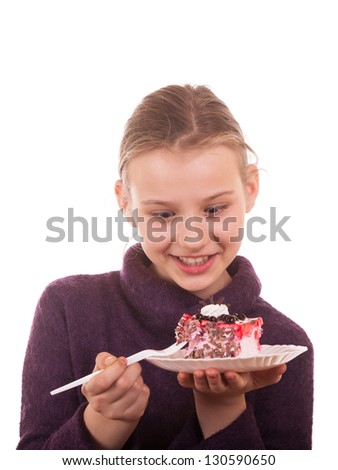 Pretty young girl looking at cake on white