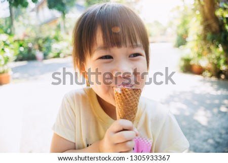 Cute happy baby girl are eating ice cream in summer. Picture for concept of sweet ,fat ,obesity and diabetes in children.