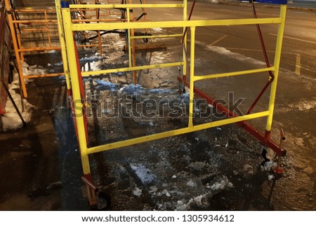 Construction of commercial premises. Scaffolding. Construction works take place in winter at night.
