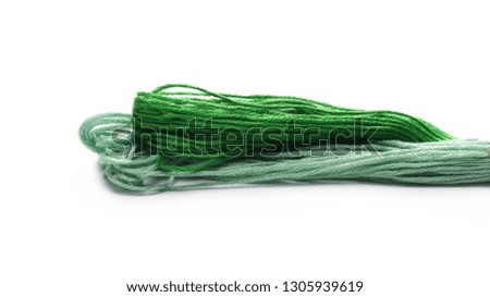 Green strings for sewing and knitting, isolated on white background