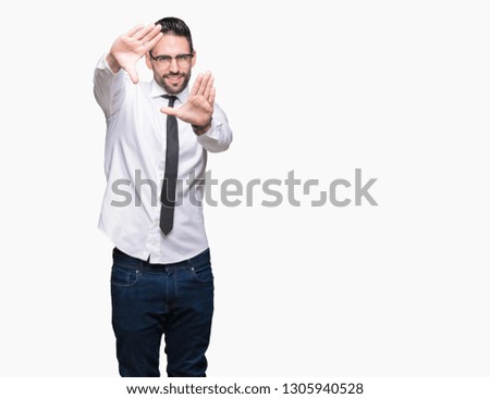 Young handsome business man wearing glasses over isolated background Smiling doing frame using hands palms and fingers, camera perspective