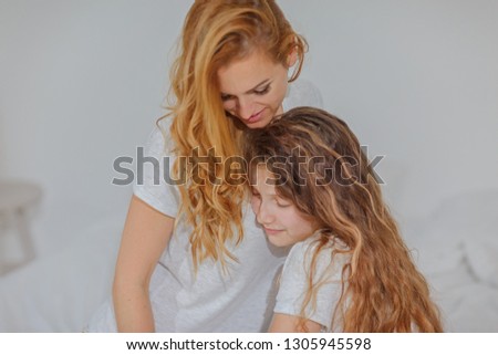 Mom and daughter teenager spend time together / portrait of mom with daughter / copy space