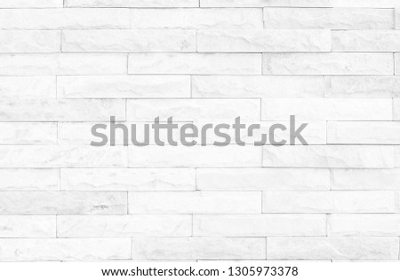 Seamless White pattern of decorative brick sandstone wall surface with concrete of modern style design decorative uneven have cracked real masonry of multicolored stones or blocks cement.