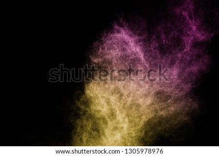 gold and purple powder effect splash for makeup artist or graphic design in black background