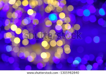 Blurred Bokeh of colorful golden and blue lightning with deep blue background