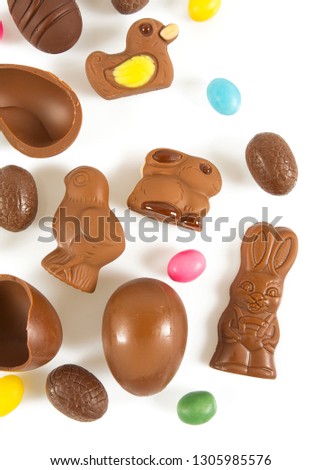 Easter composition with chocolate eggs and animals isolated on white
