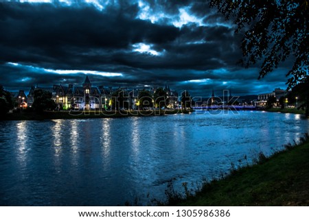Illuminated Buildings In The Scenic Streets Of The City Of Inverness At The River Ness At Night in Scotland Royalty-Free Stock Photo #1305986386