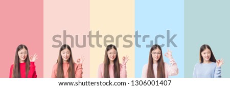 Collage of beautiful asian woman over colorful stripes isolated background smiling positive doing ok sign with hand and fingers. Successful expression.