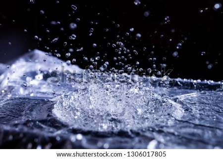 Water drops splashing on acoustic membrane. A lot of drops in air. High frequency of sound waves. Water cloud small drops. Frozen time shot. 